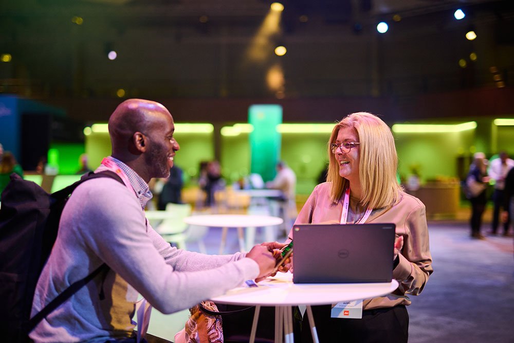 Two delegates meeting at an event.