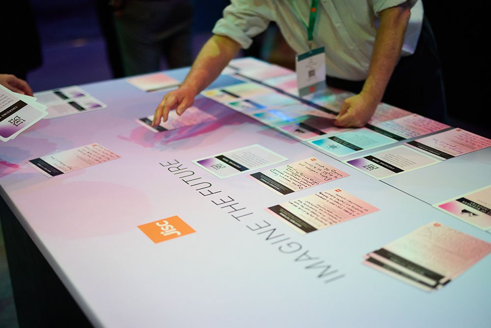 Delegates arranging cards on a table.