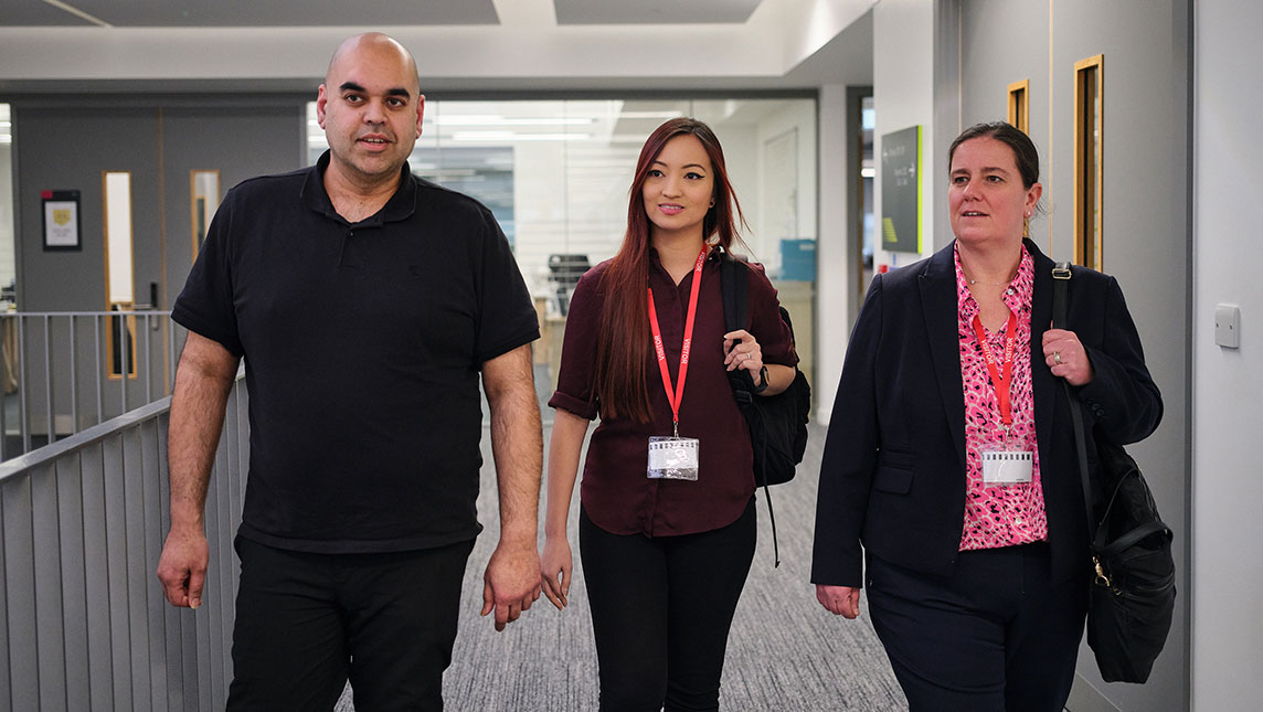 Wasif (Aston Univseristy Engineering Academy), Jen and Anne (Jisc) walk along a hallway ready to tackle the connectivity challenge.