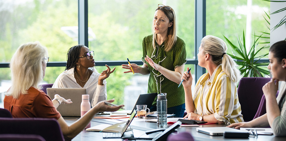 A group of female leaders in a meeting.