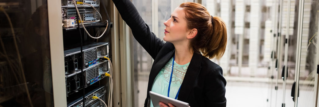 A worker checks a computer server in a data centre.