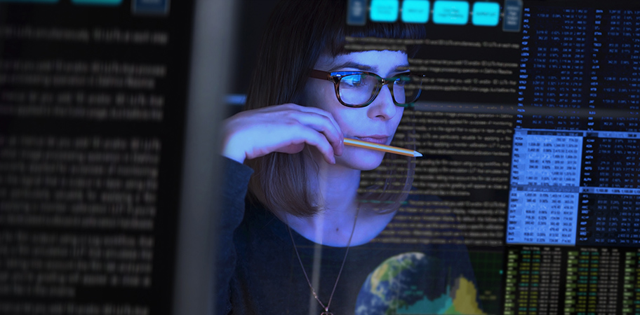 A female computer technician looking at a screen.