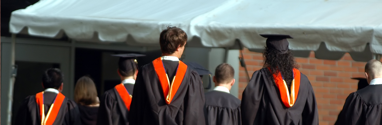 Students wearing gowns at graduation ceremony