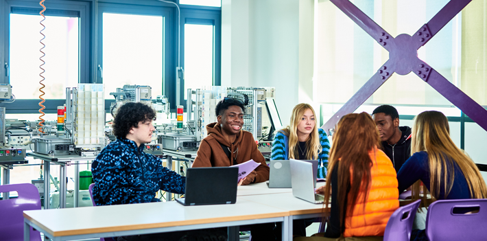 Engineering students collaborating on computer design project