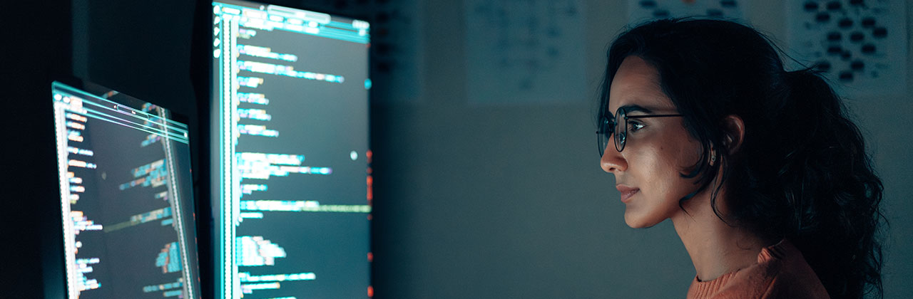 A woman looks at a computer screen.