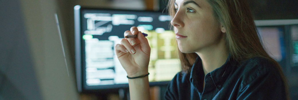 Woman working using multiple monitors