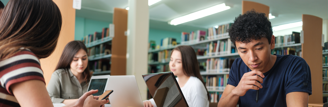 Group of students studying on laptops