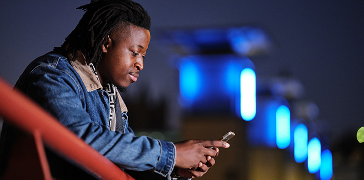 Male student looking at a phone