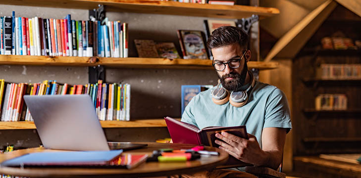 A male student studying in a library.