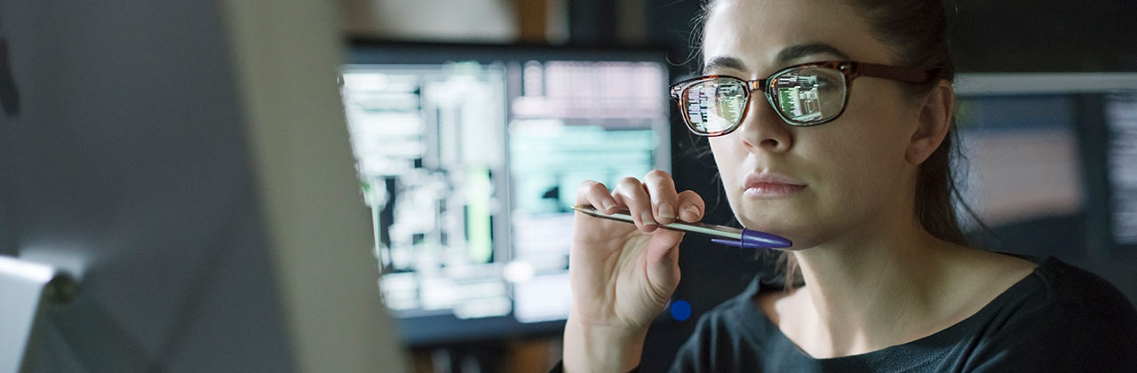An office worker looks at a computer screen.
