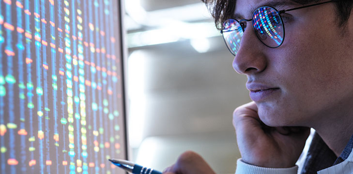 A researcher studies a computer screen.