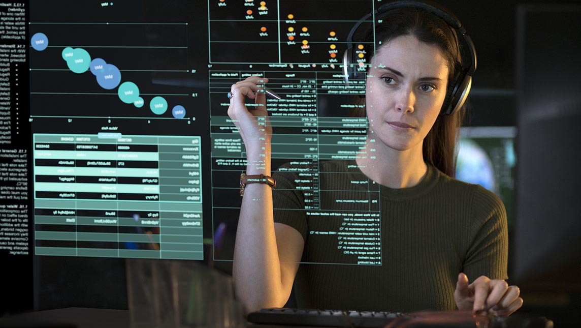 Woman studying a data screen