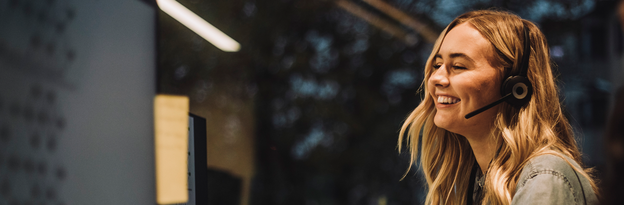 Woman taking a call using a headset.