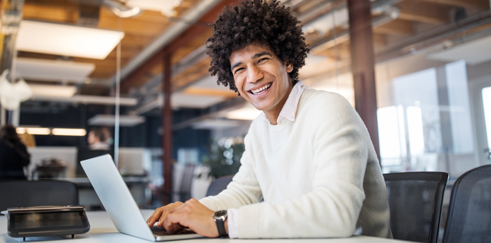 Smiling young businessman at work