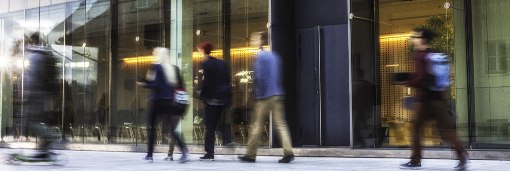 Student walk past a campus building.