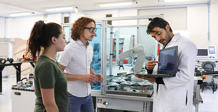 Teacher and students in engineering lab.