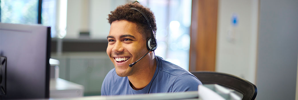 A worker uses a headset in the office.