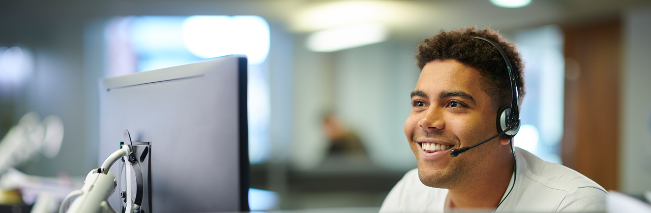 A worker uses a headset in the office.
