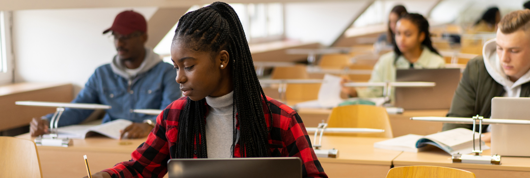 Young student is writing in the library